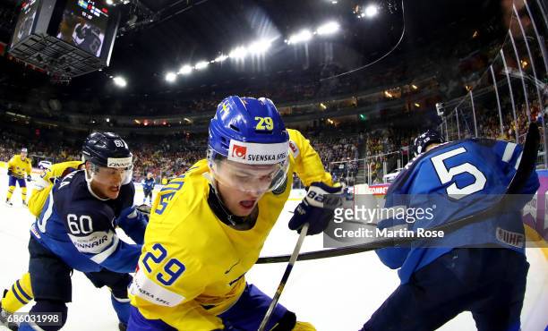 William Nylander of Sweden challenges Julius Honka of Finland for the puck during the 2017 IIHF Ice Hockey World Championship semi final game between...