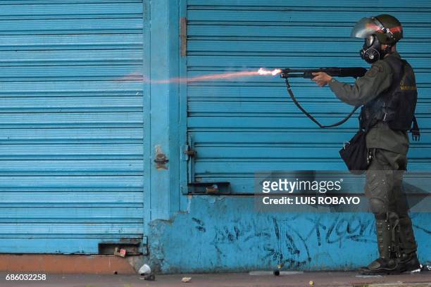 Riot police officer fires rubber bullets at demonstrators during a protest against the government of President Nicolas Maduro in San Cristobal,...
