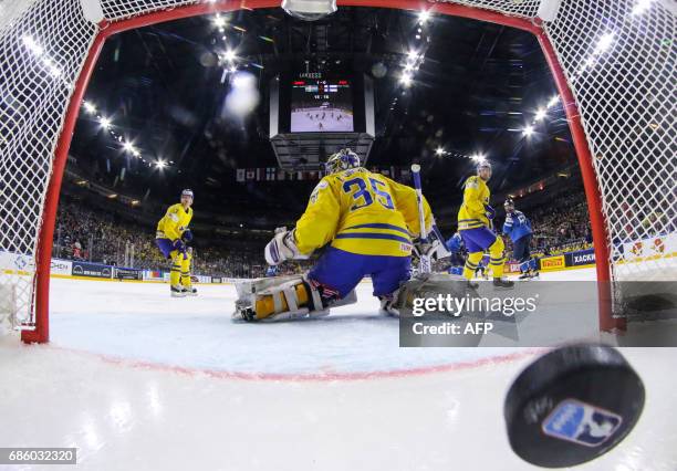 Finland scores past Sweden´s goalkeeper Henrik Lundqvist during the IIHF Men's World Championship Ice Hockey semi-final match between Sweden and...