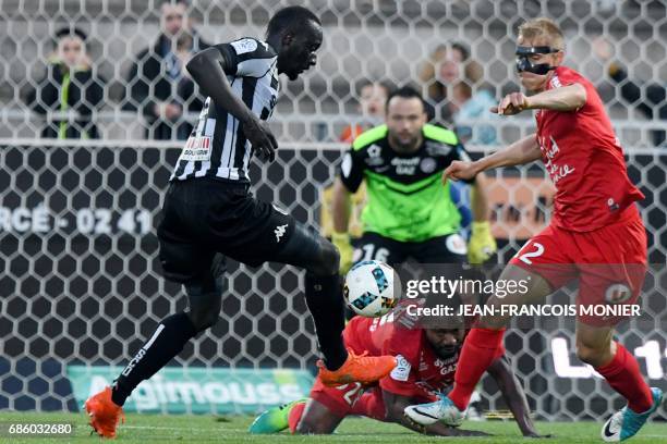 Angers' French forward Famara Diedhiou vies for the ball with Montpellier's Czech defender Lukas Pokorny during the French L1 football match between...