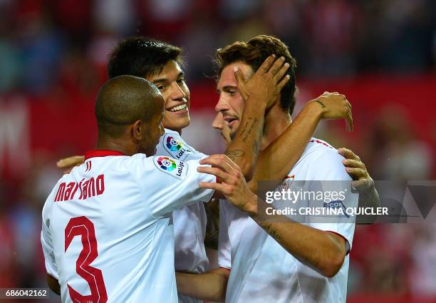 Sevilla's Italian forward Franco Vazquez celebrates after scoring a goal with Sevilla's Brazilian defender Mariano and Sevilla's Argentinian...