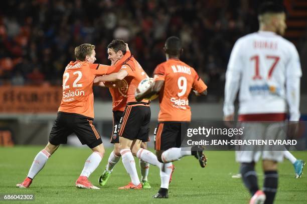 Lorient's French defender Vincent Le Goff celebrates with teammates after scoring a goal during the French L1 football match between Lorient and...