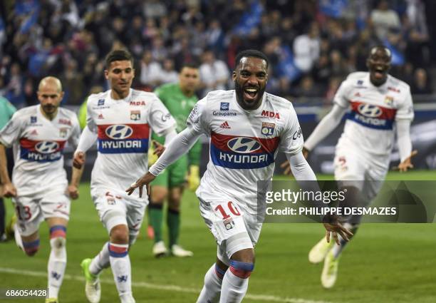 Lyon's French forward Alexandre Lacazette celebrates after scoring his 100th goal in Ligue 1 during the French L1 football match between Lyon and...