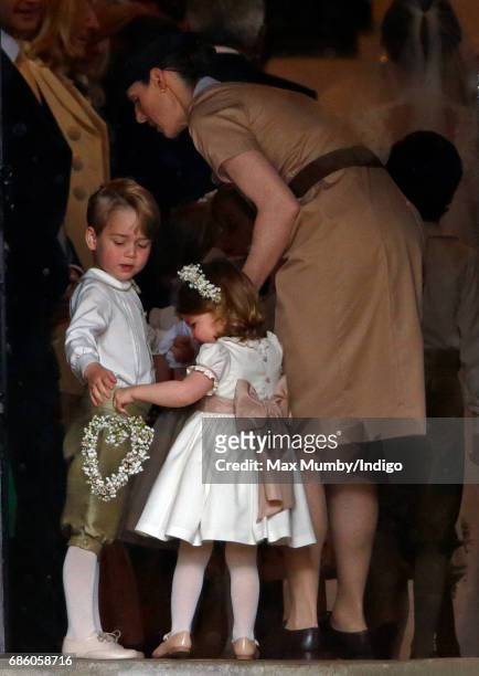 Prince George of Cambridge and Princess Charlotte of Cambridge accompanied by their nanny Maria Teresa Borrallo attend the wedding of Pippa Middleton...