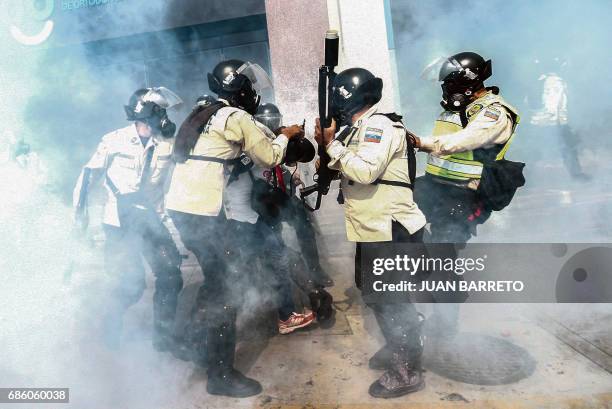 Riot police clash with demonstrators during a protest against the government of President Nicolas Maduro in Caracas on May 20, 2017. Venezuelan...