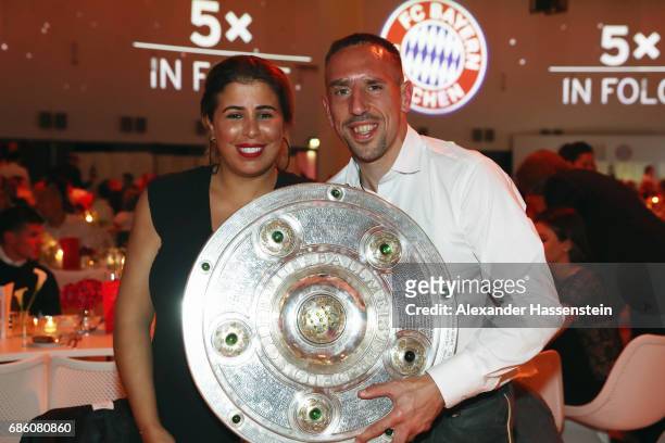 Franck Ribery and his wife Wahiba Ribery pose with the trophy during the FC Bayern Muenchen Championship party following the Bundesliga match between...