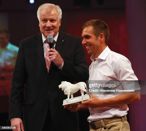 Bavarian Governor Horst Seehofer hands over the Bavarian Lion to Philipp Lahm during the FC Bayern Muenchen Championship party following the...