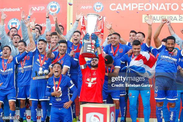 Johnny Herrera of Universidad de Chile lifts the championship cup from the podium after winning a match between Universidad de Chile v San Luis de...