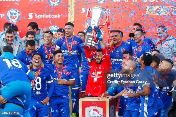 Johnny Herrera of Universidad de Chile lifts the championship cup from the podium after winning a match between Universidad de Chile v San Luis de...