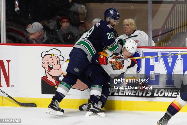 Forward Keegan Kolesar of the Seattle Thunderbirds places a hit against forward Gera Poddubnyi of the Erie Otters on May 20, 2017 during Game 2 of...