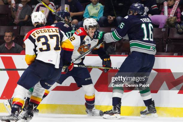 Forward Anthony Cirelli of the Erie Otters receives a glove to the face from forward Alexander True of the Seattle Thunderbirds on May 20, 2017...