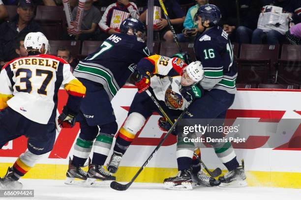 Forward Anthony Cirelli of the Erie Otters battles against forward Alexander True and Tyler Adams of the Seattle Thunderbirds on May 20, 2017 during...