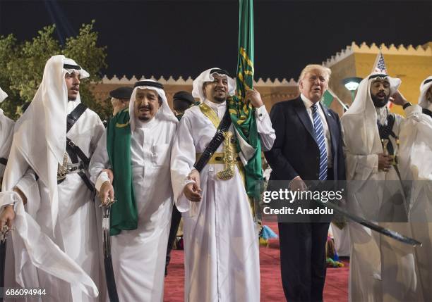 Saudi Arabia's King Salman bin Abdulaziz Al Saud and U.S. President Donald Trump join dancers with swords at Murabba Palace ahead a dinner given in...