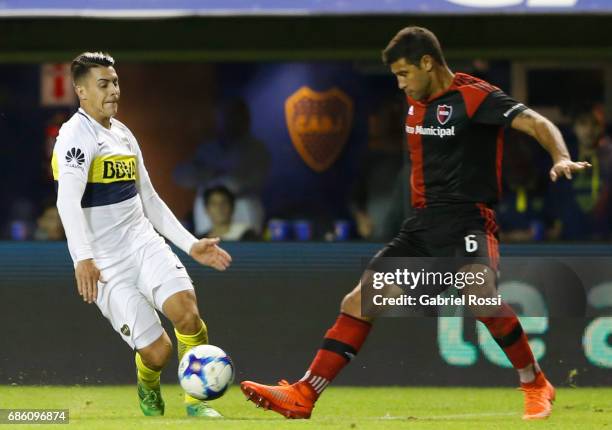 Cristian Pavon of Boca Juniors fights for the ball with Sebastian Dominguez of Newell's Old Boys during a match between Boca Juniors and Newell's Old...