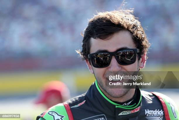 Chase Elliott, driver of the Mountain Dew Chevrolet, stands by his car during the Monster Energy NASCAR Open at Charlotte Motor Speedway on May 20,...
