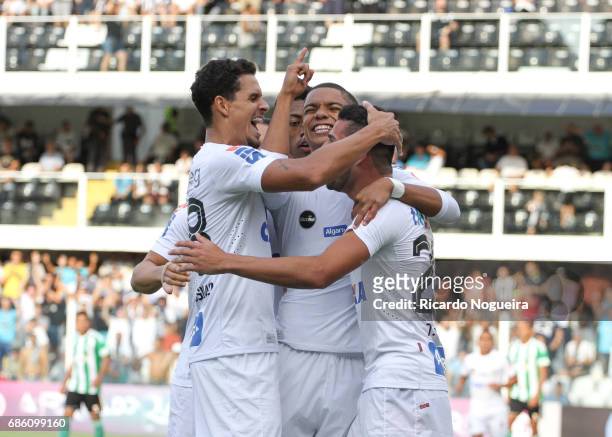 David Braz of Santos celebrates with teammates Lucas Verissimo and Thiago Maia after scoring Santos opening goal during a match between Santos and...