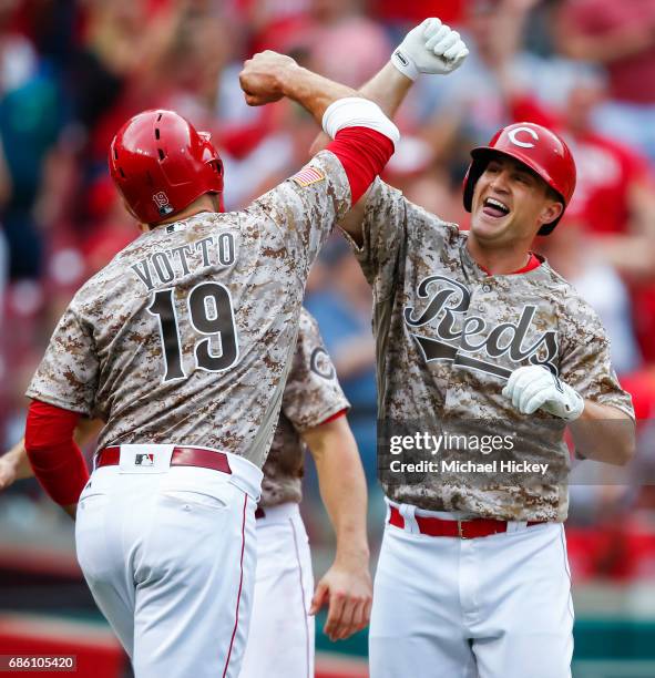 Joey Votto of the Cincinnati Reds and Scott Schebler of the Cincinnati Reds celebrate after Schebler hit a three-run homer in the sixth inning to go...