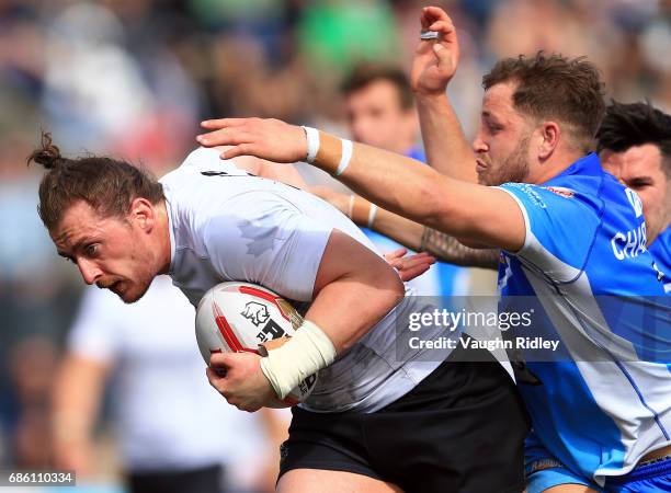 Andrew Dixon of Toronto Wolfpack is tackled by Lewis Charnock of Barrow Raiders in the first half of a Kingstone Press League 1 match at Lamport...