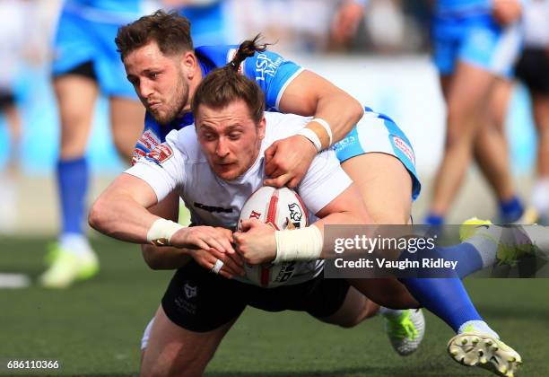 Andrew Dixon of Toronto Wolfpack scores a try as he is tackled by Lewis Charnock of Barrow Raiders in the first half of a Kingstone Press League 1...