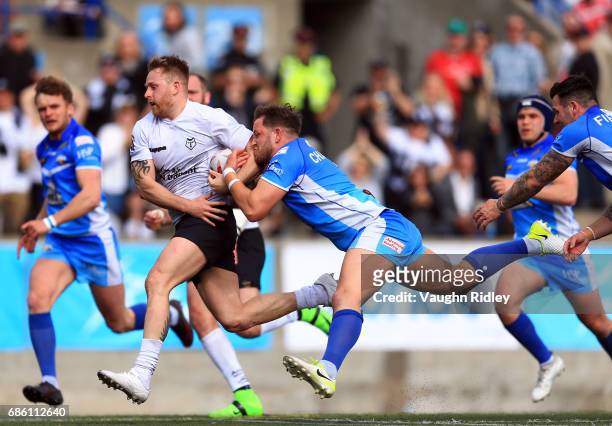 Gary Wheeler of Toronto Wolfpack is tackled by Lewis Charnock of Barrow Raiders in the first half of a Kingstone Press League 1 match at Lamport...