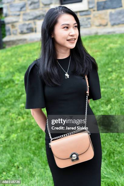 Nadya Lumanpauw is seen accesorizing a prada bag at Filbert Nickolas's Graduation at Fordham University on May 20, 2017 in Bronx, New York.