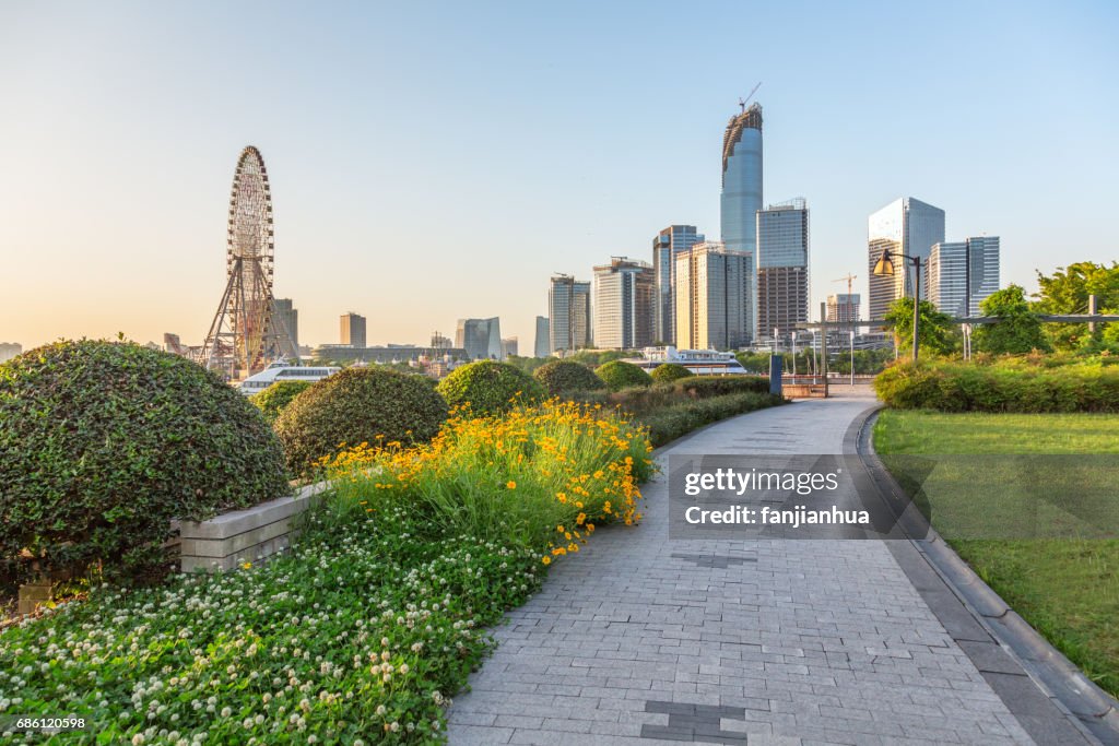 Pavement  in an urban park with business district in background