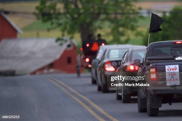 Activists, in cars decorated with protest posters against the Klu Klux Klan, caravan through the Quarryville area, where the KKK intend to hold a...