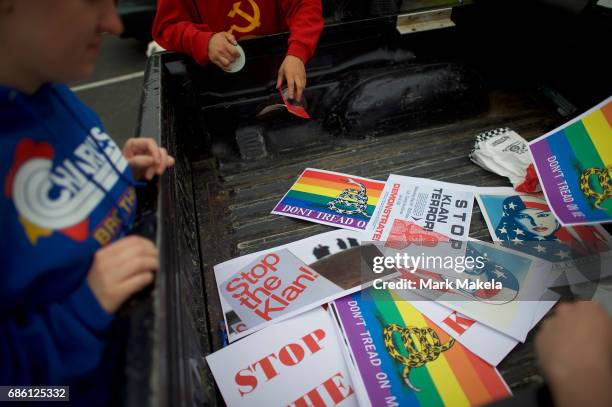 Activists gather to affix protest posters against the Klu Klux Klan to their cars before driving in a caravan through the Quarryville area, where the...