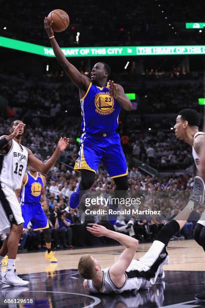 Draymond Green of the Golden State Warriors drives to the basket as Davis Bertans of the San Antonio Spurs falls down in the first half during Game...