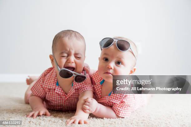 11 month old fraternal twin boys fight with each other and cry - crying sibling stock pictures, royalty-free photos & images