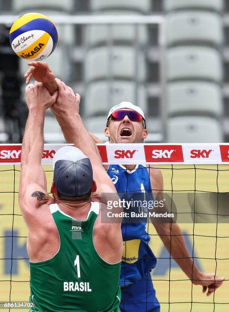 Jacob Gibb of the United States spikes the ball during the Men's Round of 03 match against Alison Cerutti and Bruno Schmidt of Brazil at Olympic Park...