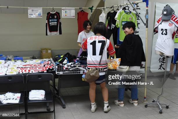 Fans check a marchandise stall prior to the J.League J3 match between Grulla Moroika and FC Tokyo U-23 at Iwagin Stadium on May 21, 2017 in Morioka,...