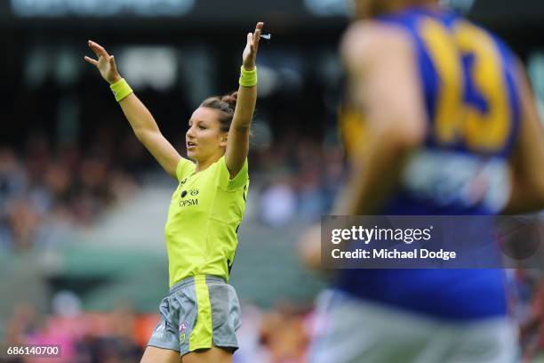 In this series Umpire Ellen Glouftsis, making her debut as the first ever women to umpire an AFL match, calls play on during the round nine AFL match...