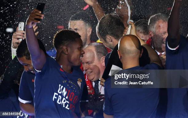 Prince Albert II of Monaco is showered with champagne during the French League 1 Championship title celebration following the French Ligue 1 match...