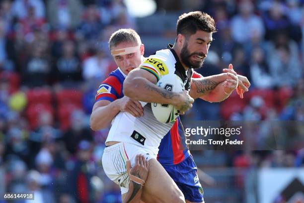 James Tamou of the Panthers is tackled during the round 11 NRL match between the Newcastle Knights and the Penrith Panthers at McDonald Jones Stadium...