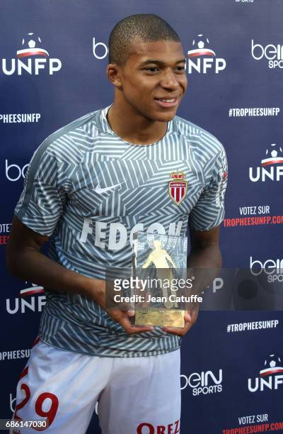 Kylian Mbappe of Monaco receives the trophy of 'best newcomer of the season' before the French Ligue 1 match between AS Monaco and AS Saint-Etienne...