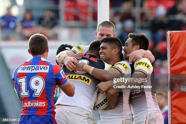 Panthers players celebrate a try from James Tamou during the round 11 NRL match between the Newcastle Knights and the Penrith Panthers at McDonald...