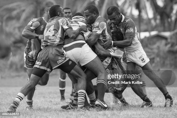 Coastal Owls player is tackled by the Coastline Roos defence during the Fiji National Rugby League western conference Nadroga zone Premier...
