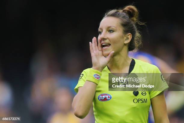 In this series Umpire Ellen Glouftsis, making her debut as the first ever women to umpire an AFL match, shouts instructions during the round nine AFL...