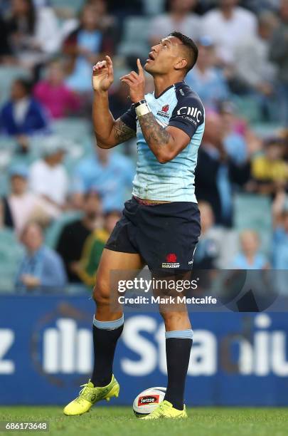 Israel Folau of the Waratahs celebrates scoring a try during the round 13 Super Rugby match between the Waratahs and the Rebels at Allianz Stadium on...