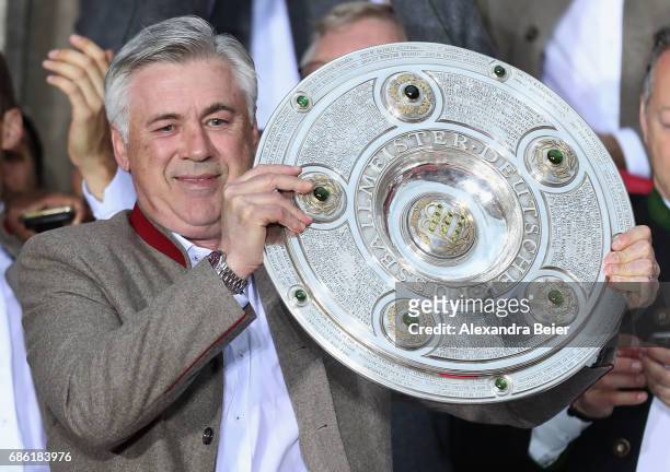 Team coach Carlo Ancelotti of Bayern Muenchen celebrates with teammates and staff winning the 67th German Championship title on the town hall balcony...