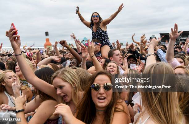 Race fans party in the infield to the music of DJ Zedd who is Anton Zaslavskia a Russian-born DJ, during the 142nd running of the Preakness Stakes at...