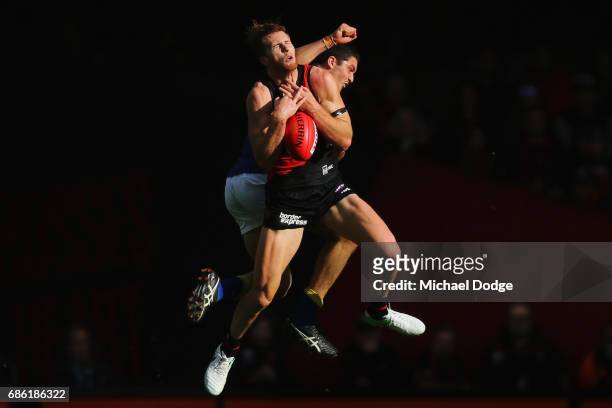 James Stewart of the Bombers compete for the ball in front of Tom Barrass of the Eagles during the round nine AFL match between the Essendon Bombers...