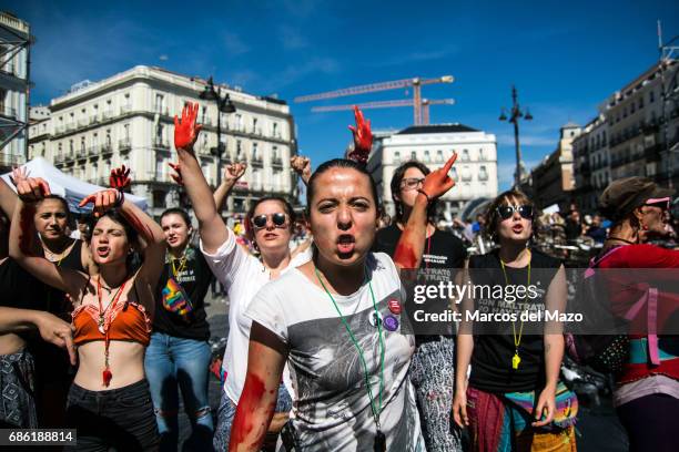 Women with their hands painted in red protesting against gender violence demanding to all political parties to take actions.