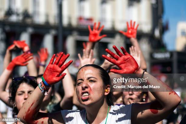 Women with their hands painted in red protesting against gender violence demanding to all political parties to take actions.