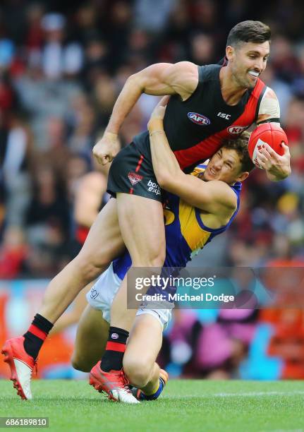 Jack Redden of the Eagles tackles David Myers of the Bombers during the round nine AFL match between the Essendon Bombers and the West Coast Eagles...