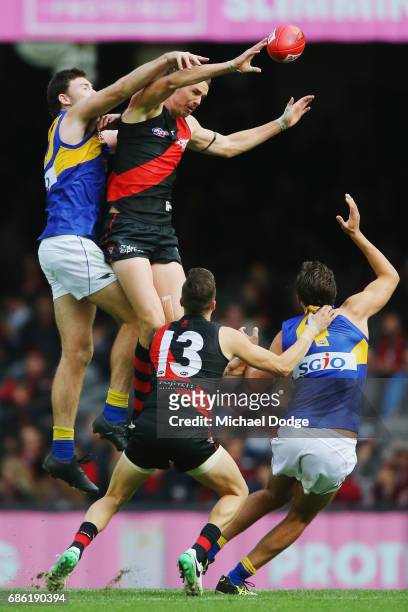 Joe Daniher of the Bombers taps the ball down from Jeremy McGovern of the Eagles in the ruck during the round nine AFL match between the Essendon...