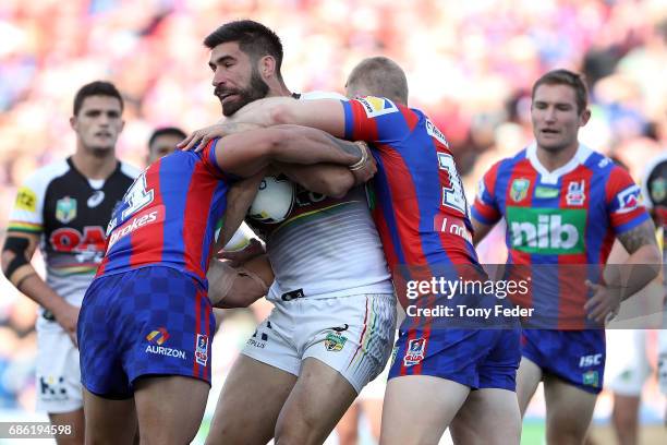 James Tamou of the Panthers is tackled during the round 11 NRL match between the Newcastle Knights and the Penrith Panthers at McDonald Jones Stadium...