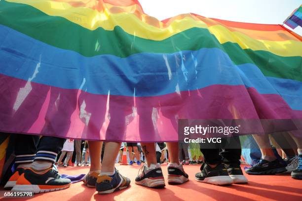 People holding the rainbow flag participate in the color run on May 21, 2017 in Taiyuan, Shanxi Province of China. Around 300 people including about...