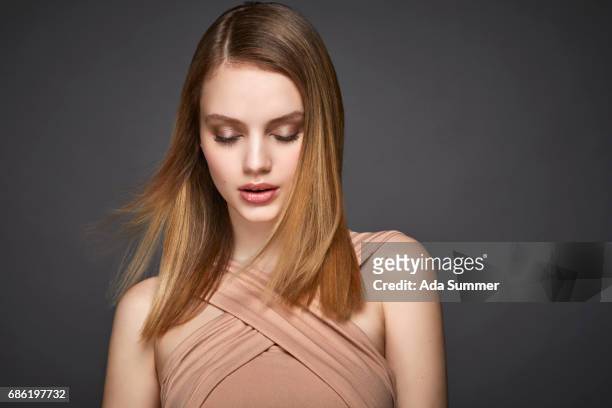 studio shot of a beautiful young woman - vestido color carne fotografías e imágenes de stock